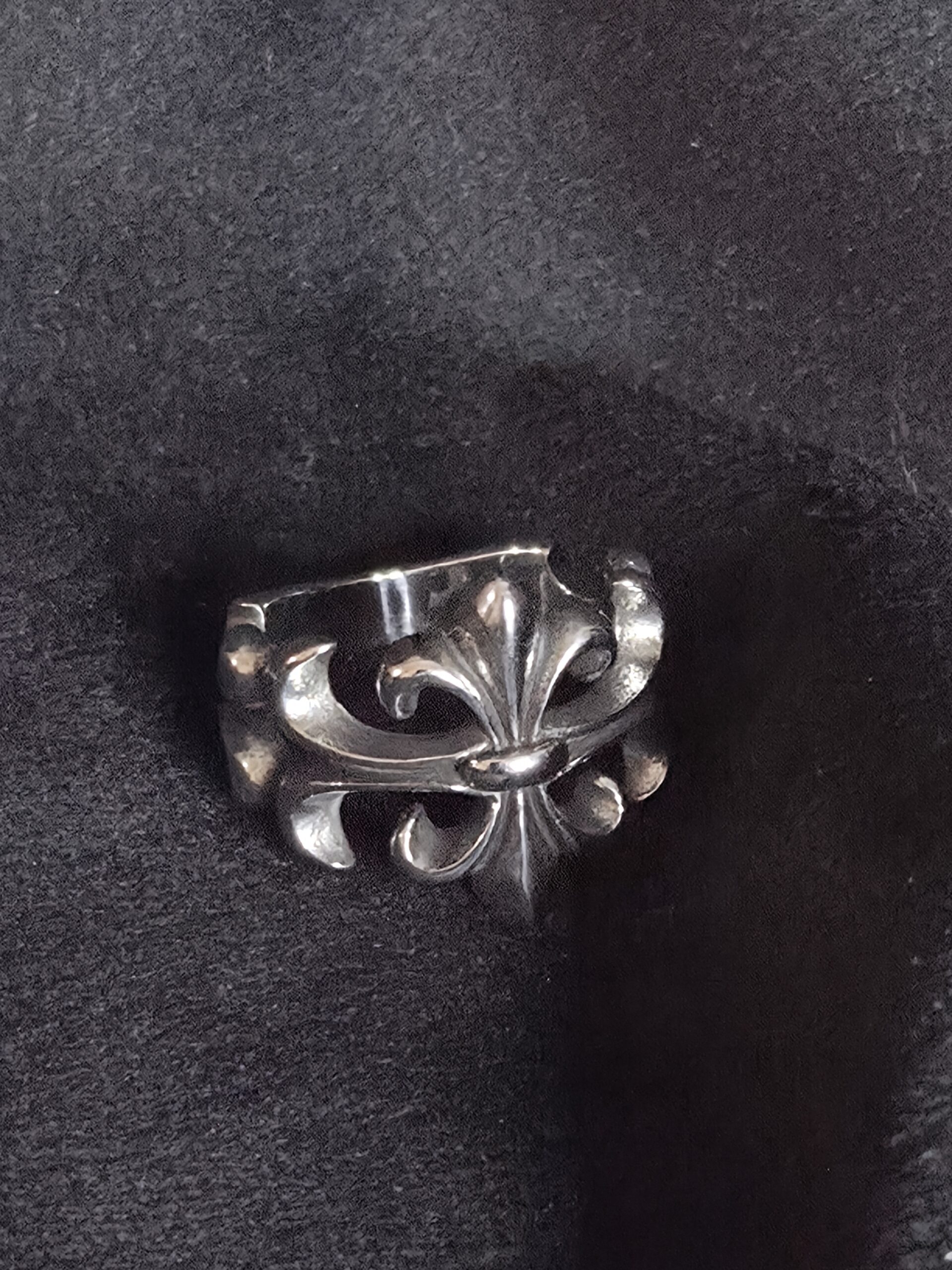 Gootti fleur-de-lis sormus, ruostumatonta terästä mustalla taustalla
